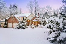 Last Light Fades As Night Falls On A Snowy Suburban Home And Garden