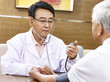 © imtmphoto - asian doctor checking blood pressure of a senior patient
