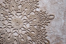 Handmade Crocheted Doily With Grey Cotton Threads On A Neutral G