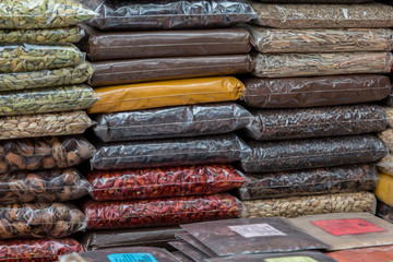 Packets of various spices piled high on a market stall in Zanzibar Stone town.