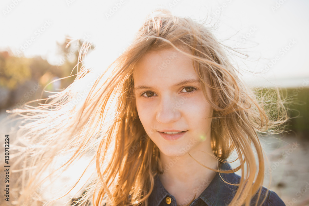 Portrait of a beautiful girl with long hair at the beach. Girl walking ...