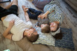 © natalialeb - Happy pregnant mother, father and son Toddler lying on the floor