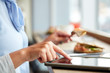 © Syda Productions - woman with tablet pc and panini sandwich at cafe