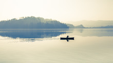 Zen On The Lake. Fog Over The Lake. In Calm Water Reflection Mirror. Man With A Paddle In The Boat. 