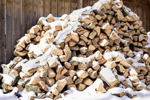 Stacked Firewood Covered In Snow