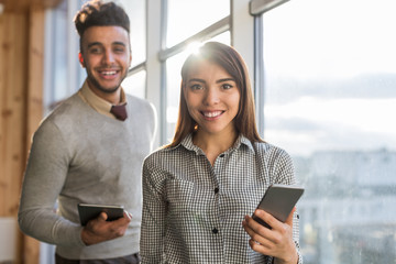 Canvas Print - Mix Race Business Man Woman Using Cell Smart Phone Stand in front Panoramic Window Happy Smiling Businesspeople In Coworking Center Office Interior