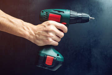 male hand holding a screwdriver, for screwing screws