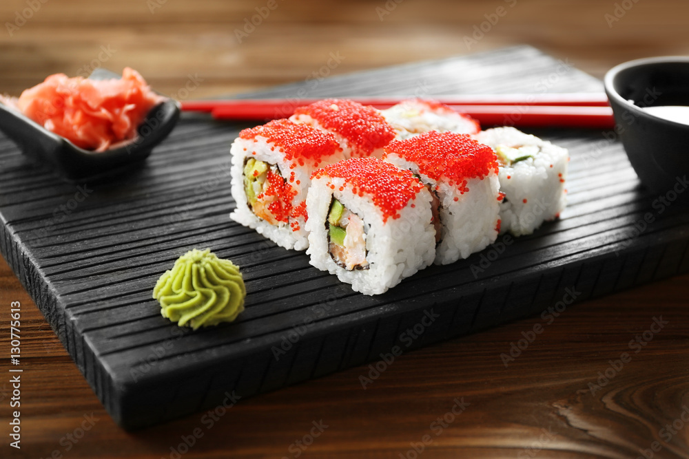 Delicious sushi set on wooden board