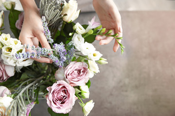 Female florist making beautiful bouquet at flower shop