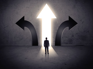 Businessman in front of three arrows