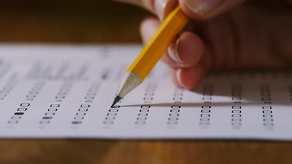 4k close up of pencil being used on a multiple choice test paper