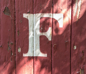 F on red-Painted Wood Siding