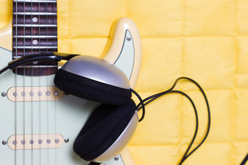 Wall Mural - headphone on yellow electric guitar for music background