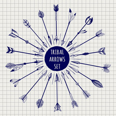 Wall Mural - Hand drawn tribal arrows set on notebook page background. Vector illustration