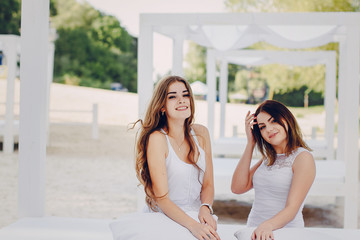 two girls resting on the beach