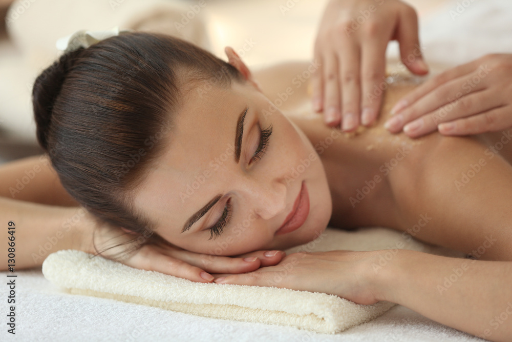 Spa concept. Hands massaging female back with scrub