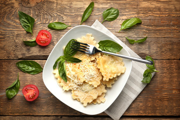 Canvas Print - Plate of ravioli with cheese on table