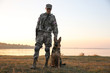 © Africa Studio - Soldier with german shepherd dog near river at sunset