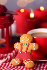 Wall Mural - Composition of tasty gingerbread cookie and cup of coffee on kitchen table, close up view