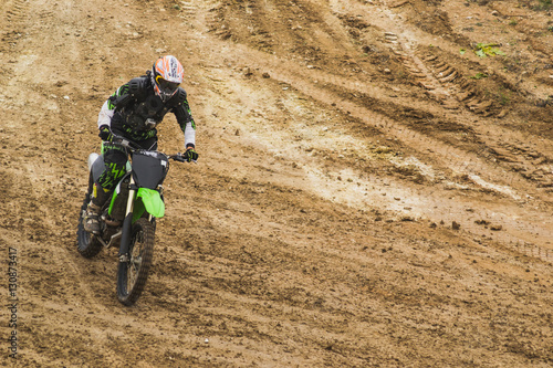 Photographie  Bike rider moves through dirt at motocross