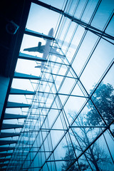 Wall Mural - airplane above the glass building