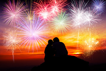 Wall Mural - Happy couple sitting on floor and watching the fireworks