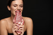 © puhhha - Eating Meat. Beautiful Woman Biting Raw Beef Steak Meat