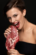 © puhhha - Eating Meat. Beautiful Woman Biting Raw Red Beef Steak Meat