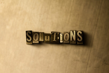 SOLUTIONS - close-up of grungy vintage typeset word on metal backdrop. Royalty free stock - 3D rendered stock image.  Can be used for online banner ads and direct mail.