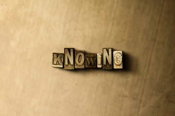 knowing - close-up of grungy vintage typeset word on metal backdrop. royalty free stock - 3d rendere