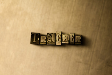 TRACKER - close-up of grungy vintage typeset word on metal backdrop. Royalty free stock - 3D rendered stock image.  Can be used for online banner ads and direct mail.