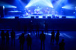 © Anatoliy Karlyuk - Blurred concept of night life. Crowd in front of stage with blue concert lights.