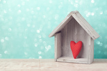 Valentine's Day Concept With Heart Shape And House Over Rustic Background