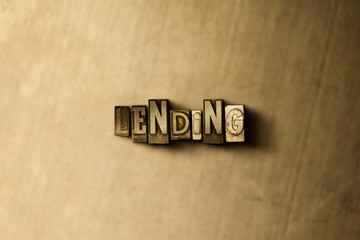 LENDING - close-up of grungy vintage typeset word on metal backdrop. Royalty free stock - 3D rendered stock image.  Can be used for online banner ads and direct mail.