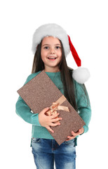 Wall Mural - Cute little girl in Santa hat with Christmas gift on white background