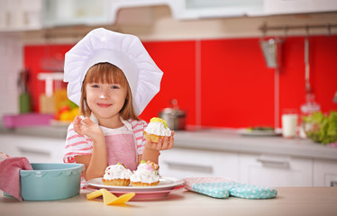 Poster - Little girl with cakes in kitchen