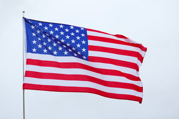 Wall Mural - United States national flag on grey sky background