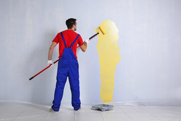 Sticker - Young worker painting wall in room