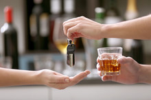 Drunk Man Giving Car Key To Woman, On Blurred Background. Don't Drink And Drive Concept