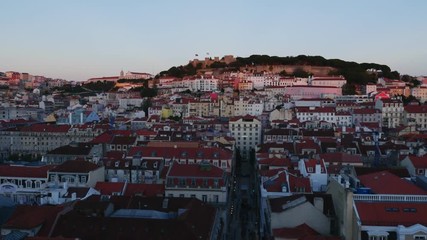 Wall Mural - Portugal, Lisbon, Miradouro de Santa Justa, View over downtown and Santa Justa Street towards the castle hill at sunset.
