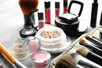 Decorative cosmetic set on grey textured background