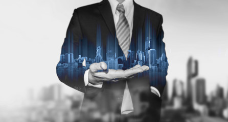 double exposure businessman holding blue city hologram, real estate business technology