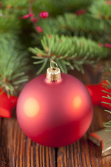 Sticker - Red Christmas bauble on wooden background