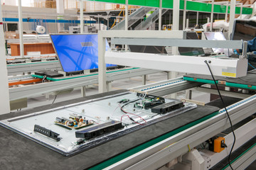 closeup line conveyor assembly  televisions in a workshop