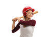 Female baseball player with a wooden bat ready to strike