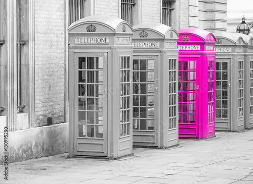 Tapeta ścienna na wymiar Five Red London Telephone boxes all in a row, in black and white with one booth in pink