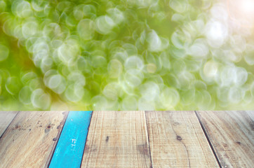 Nature green bokeh sun light on old empty wood table background.