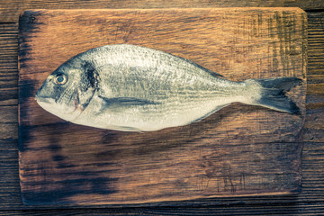 Wall Mural - Fresh catch whole fish on wooden board