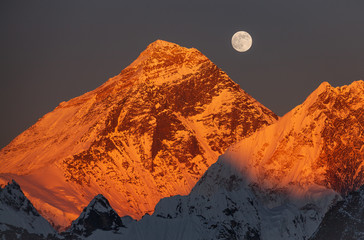 Majesty of nature. Golden pyramid of Mount Everest (8,848 m) at sunset on a full moon.