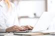 © peshkova - Woman typing on laptop keyboard